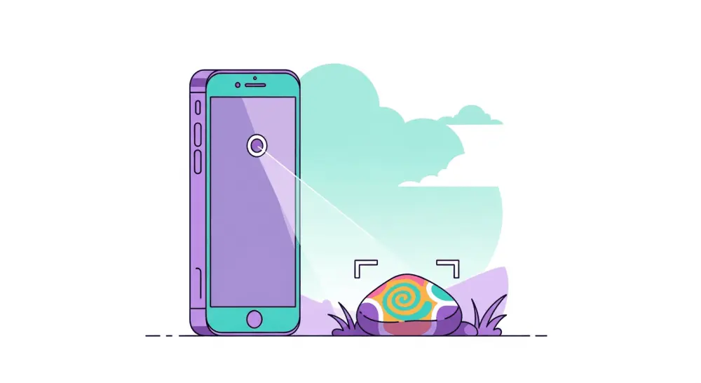 Smartphone scanning a painted rock outdoors for tracking